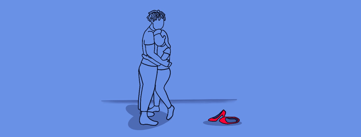 Man hugging woman, couples embrace, with red heels discarded to the side.